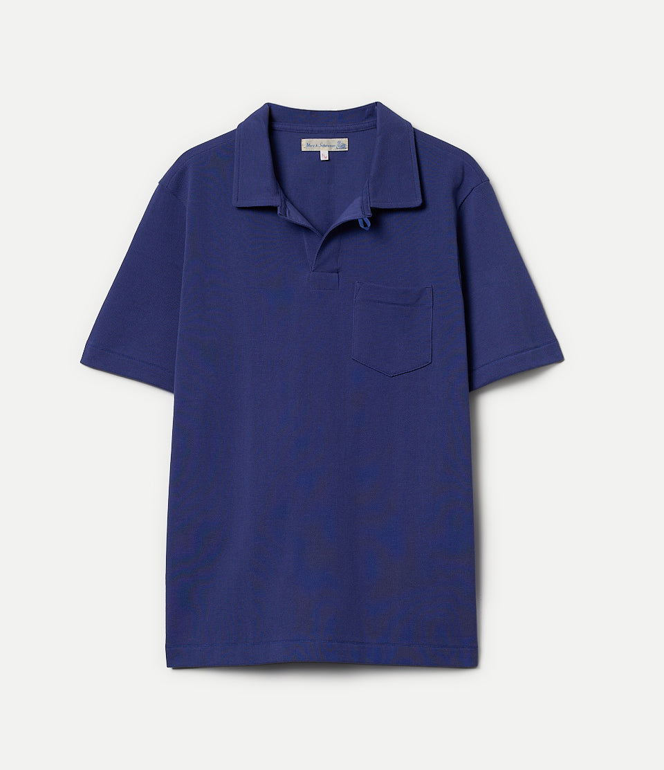 Blue loopwheeled polo shirt on a hanger against a white background