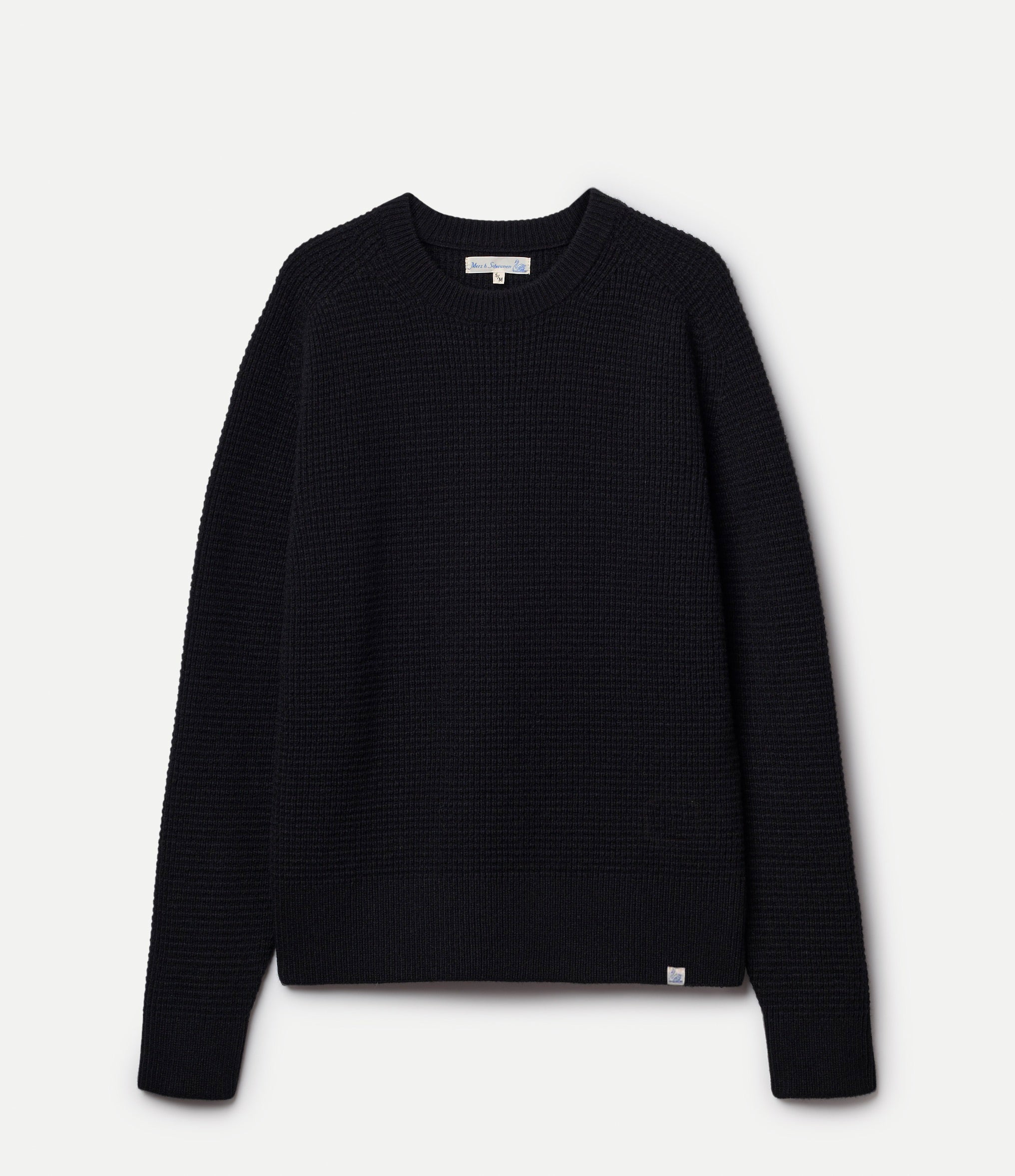 Black textured sweater on a light gray background