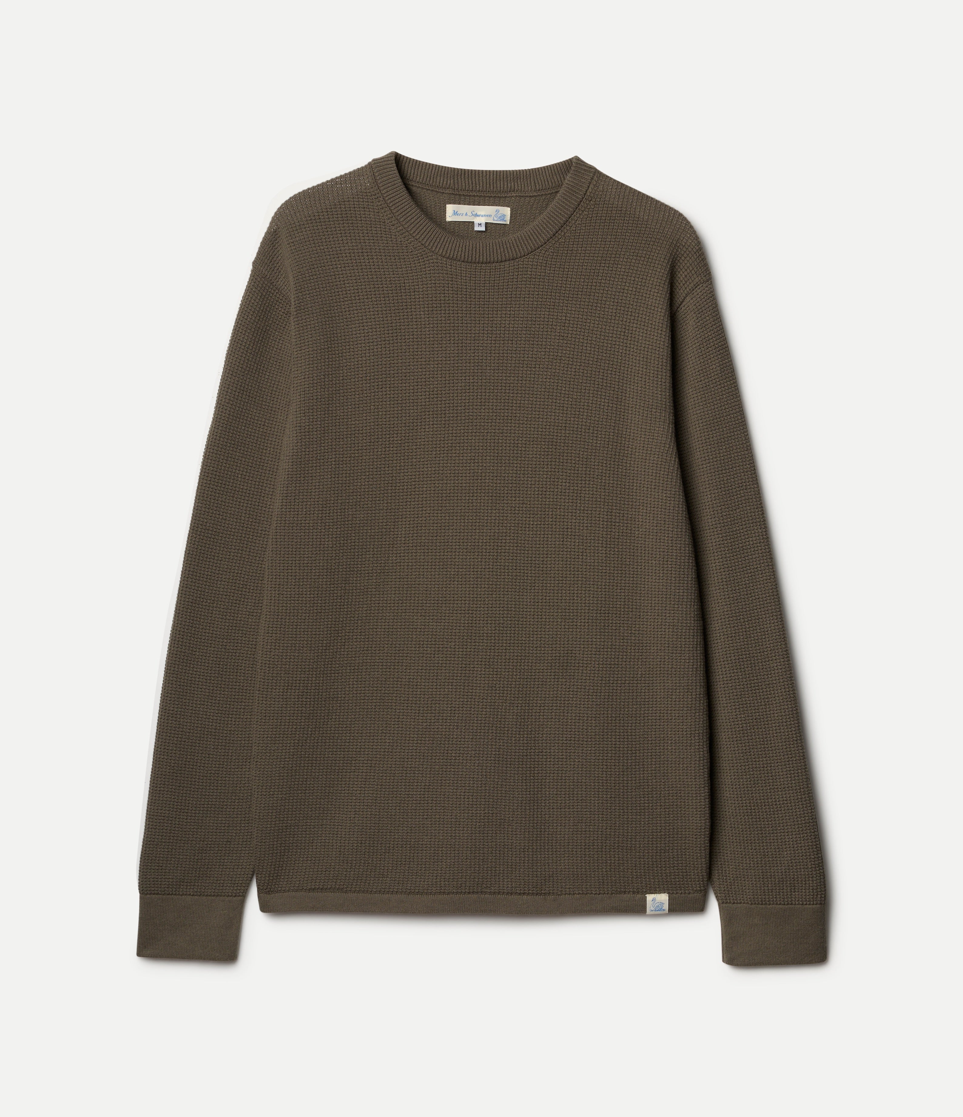 Army green ribbed knit crewneck sweater with long sleeves, shown flat against a light off-white background.