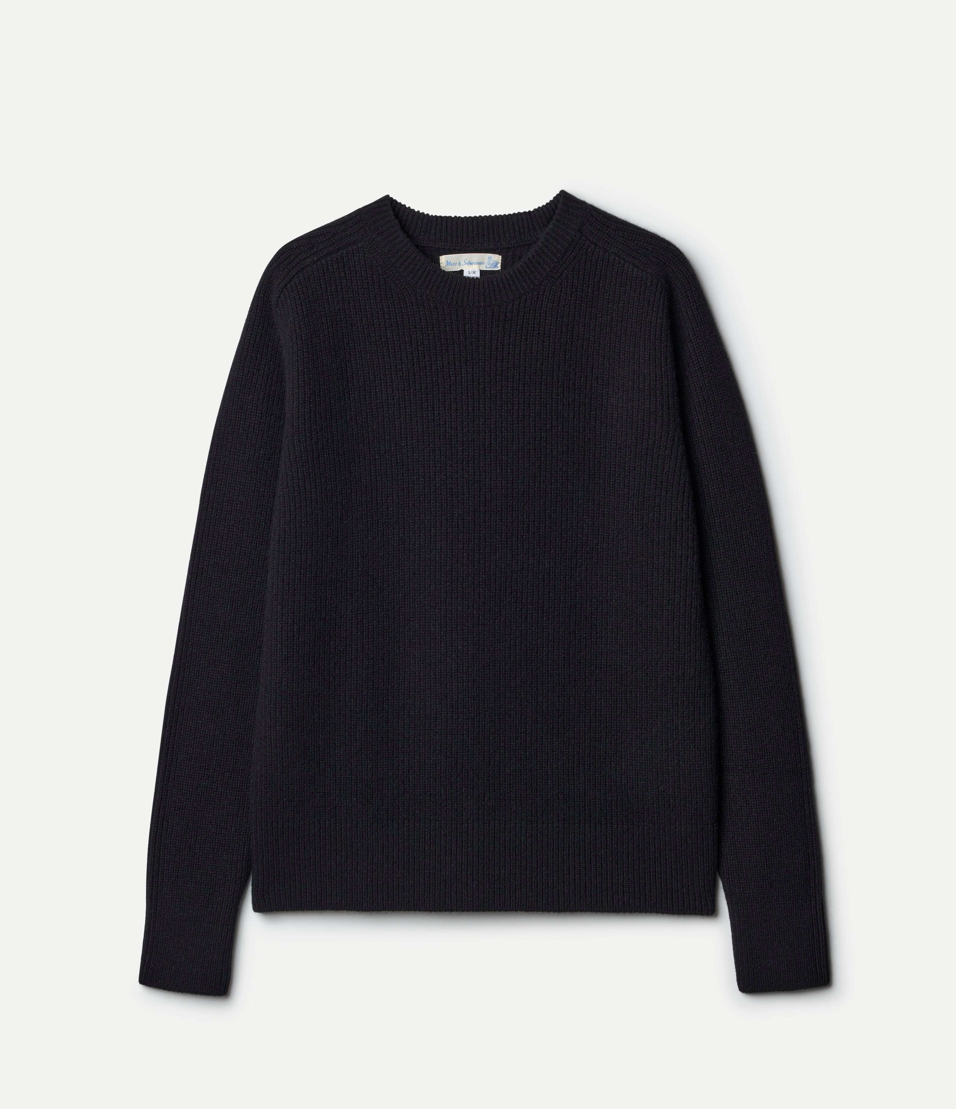 Black ribbed sweater on a light gray background