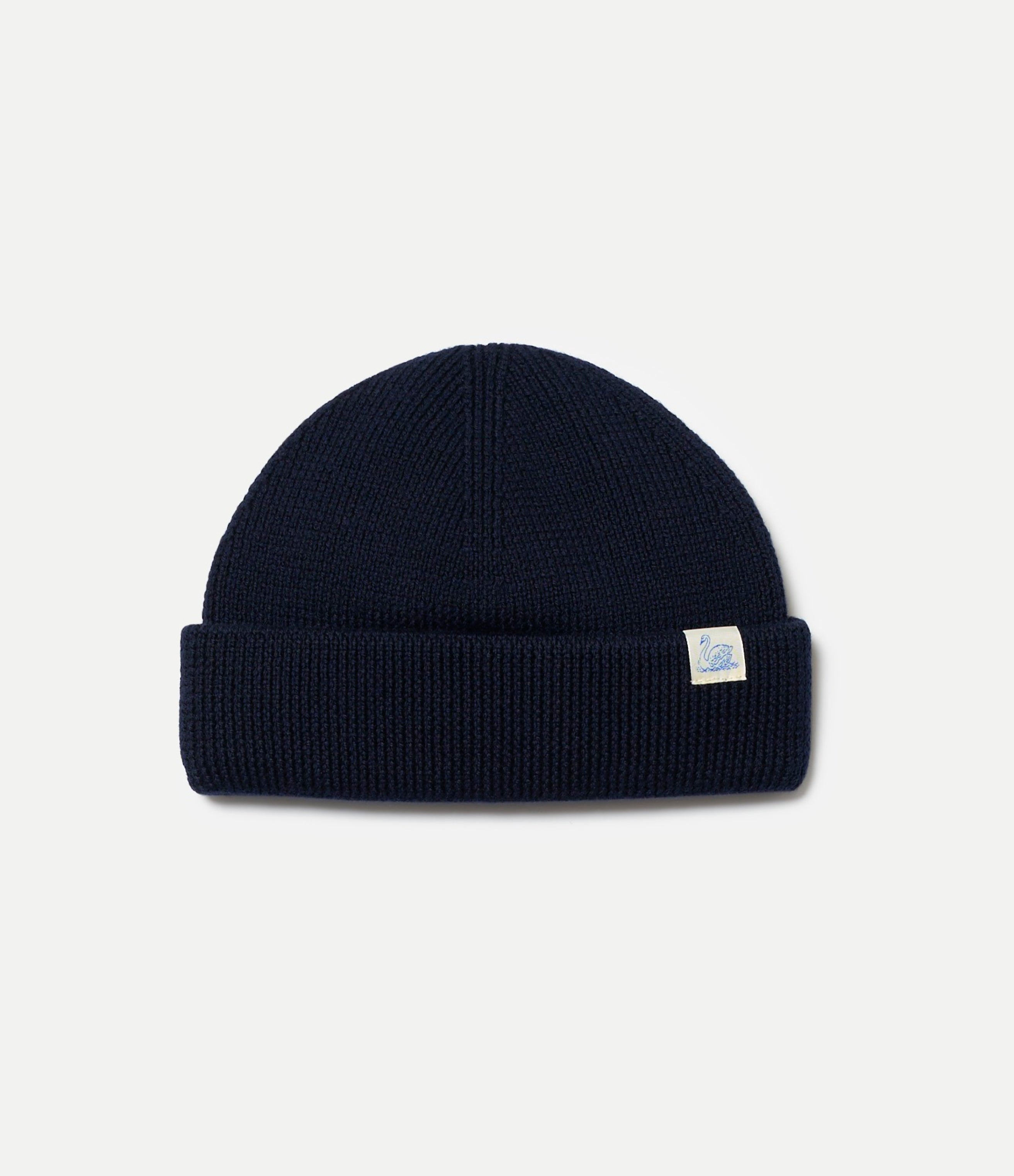 Navy blue merino wool beanie with a Swan brand logo on a light gray background