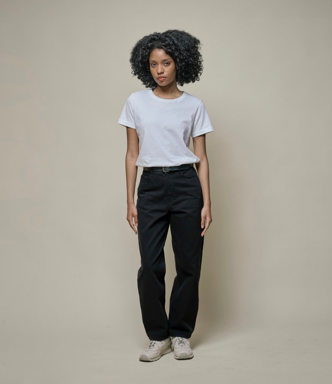 Person wearing black cotton twill pants and white T-shirt