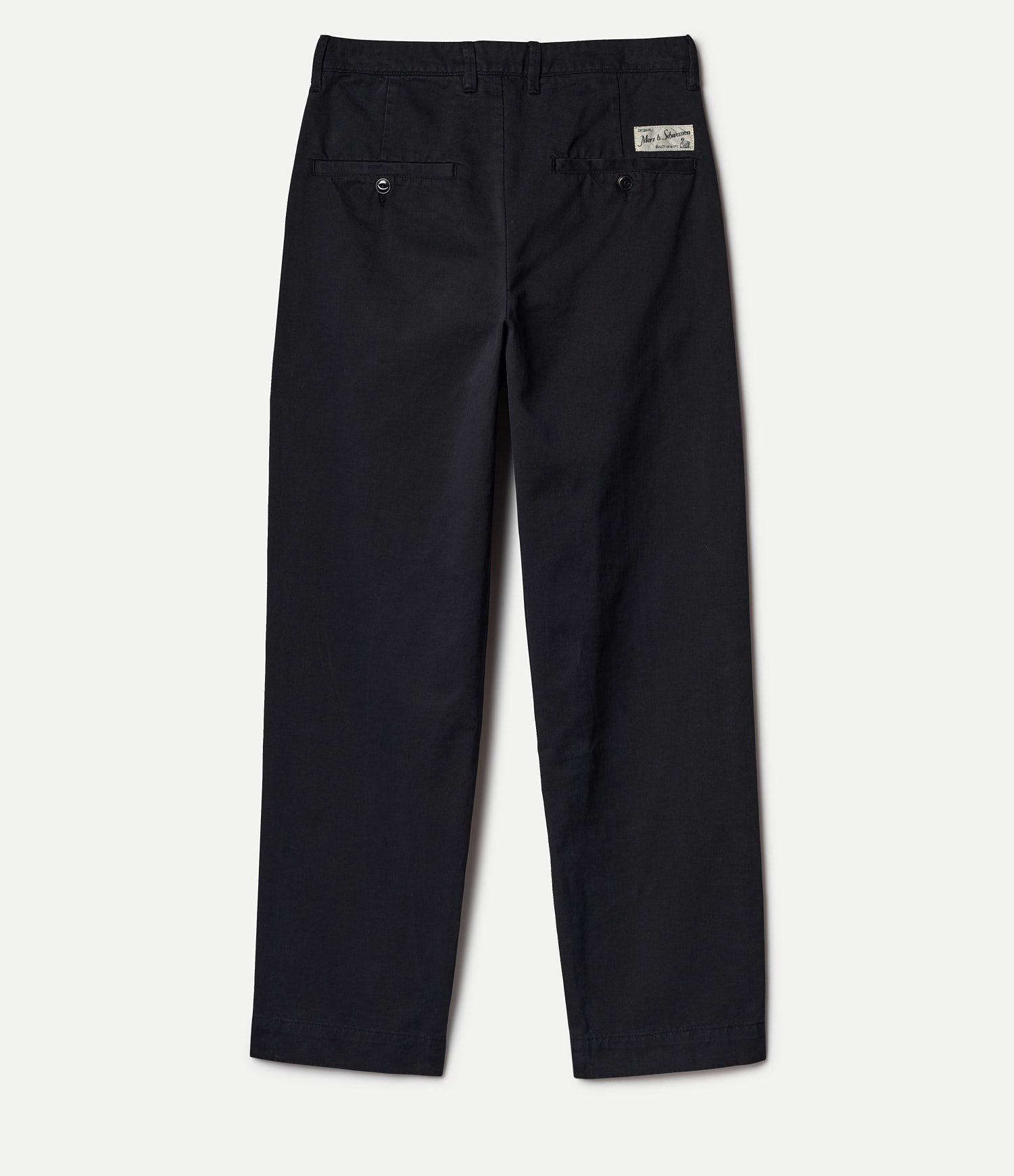 Backside of black twill pants with a Merz b. Schwanen logo on a white background