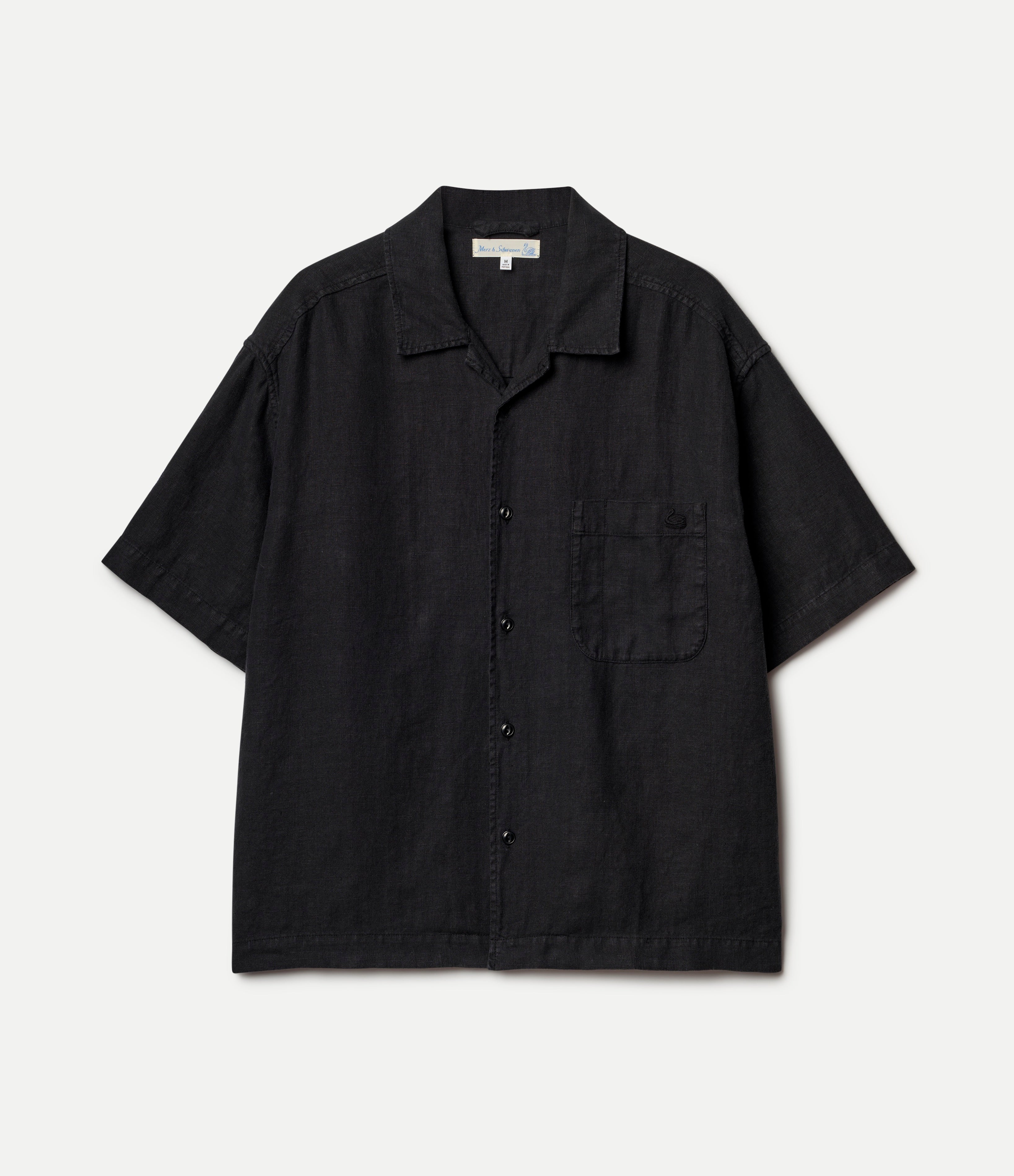 Black short-sleeve linen bowling shirt on a light gray background
