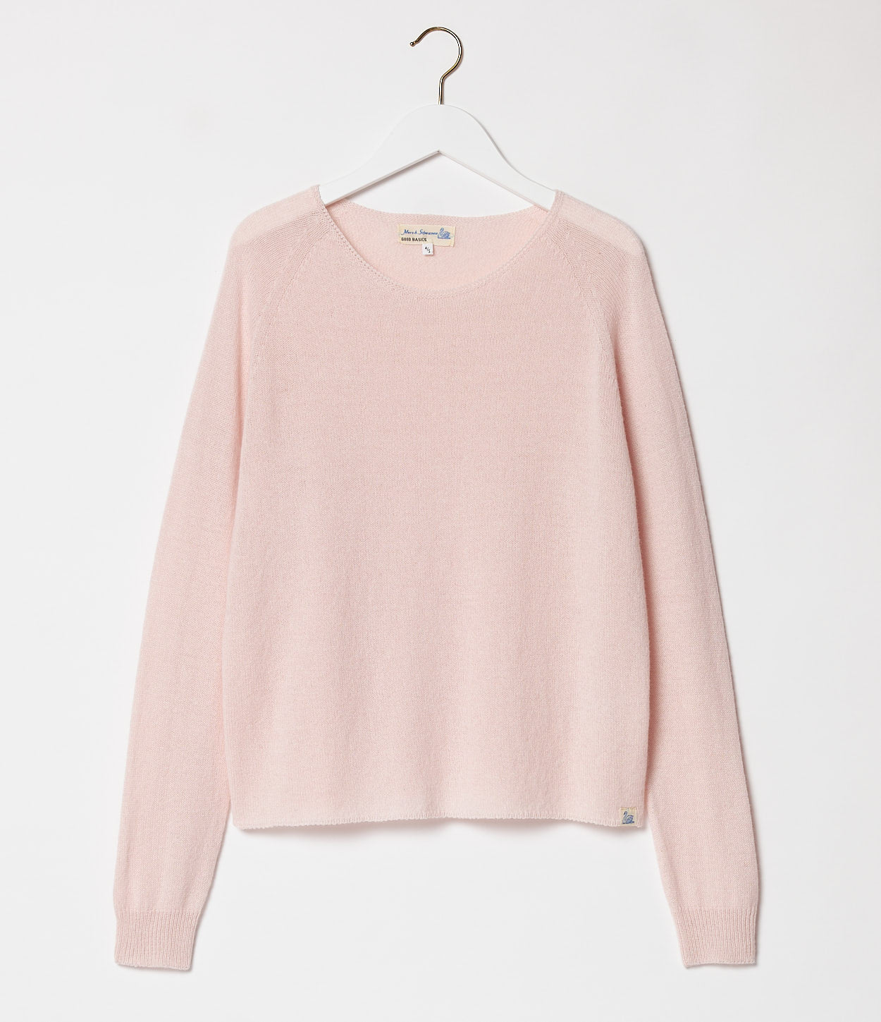 Pink sweater on a hanger against a white background