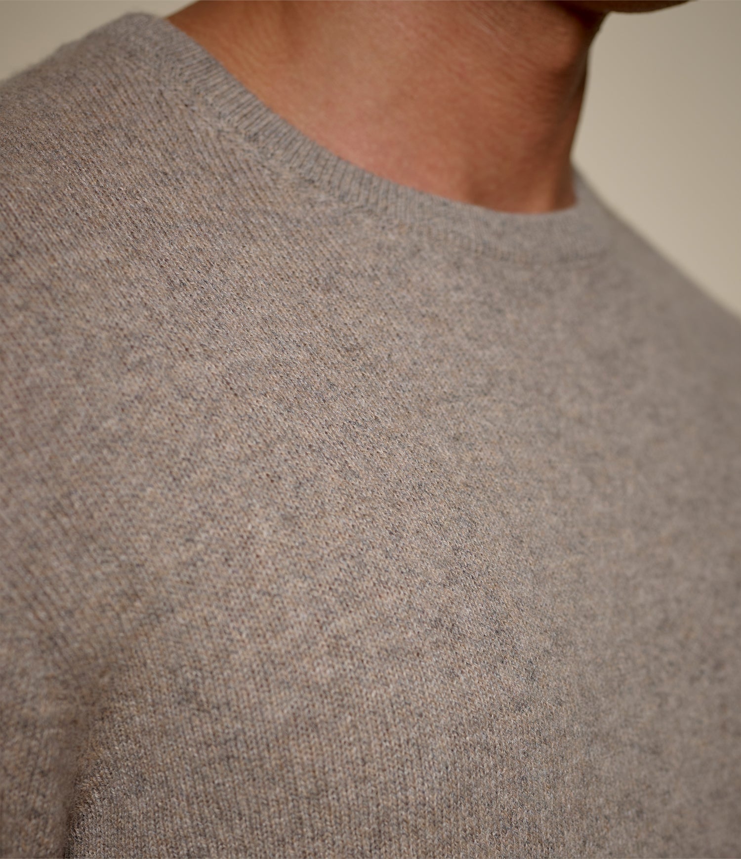 Close-up of a gray sweater with a neutral background
