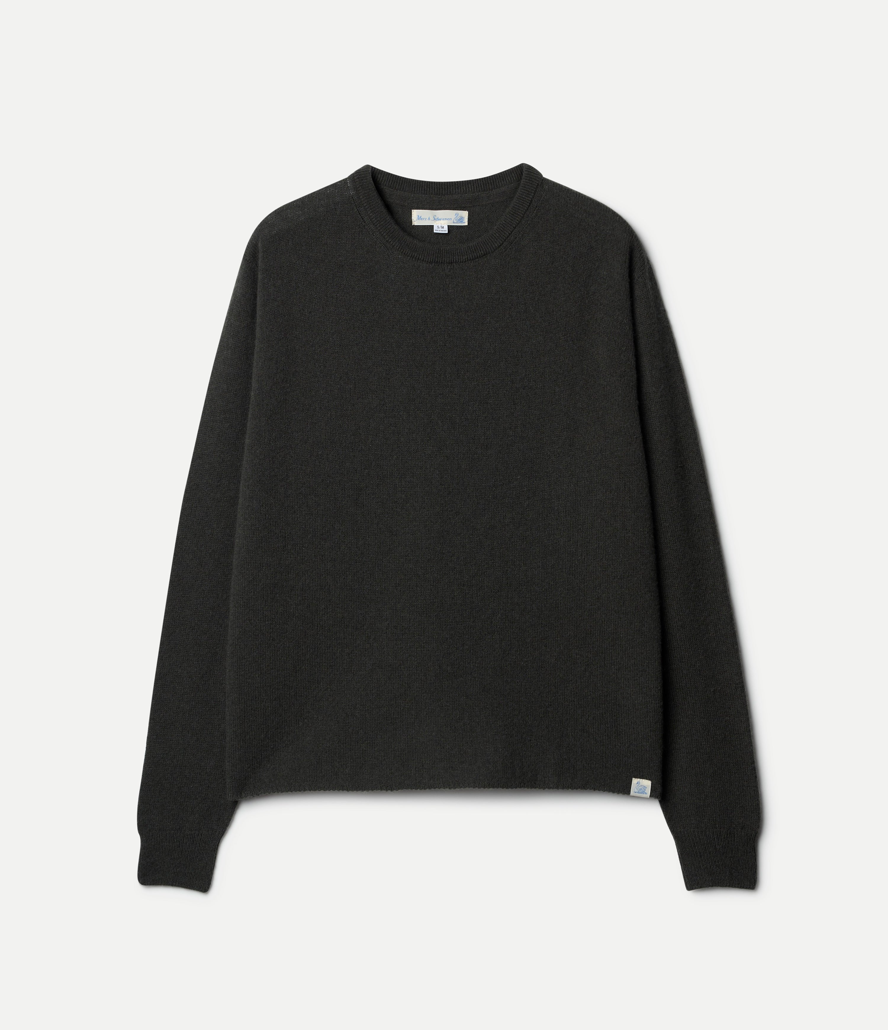 A green, long-sleeved, extra-fine merino wool-cashmere-silk sweater against a white background.