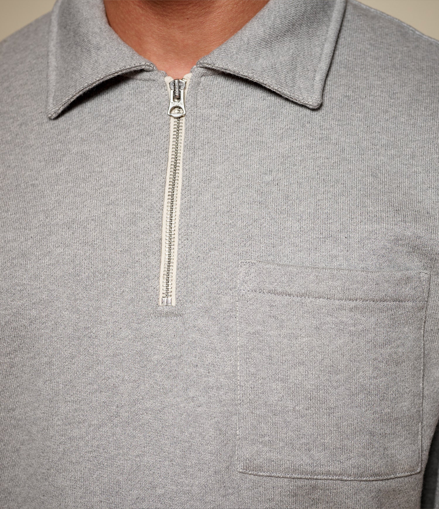Gray zip-up sweatshirt with a pocket and zipper detail